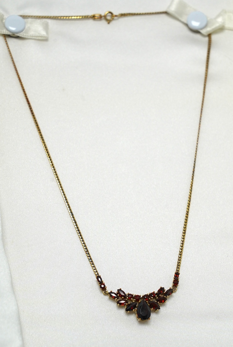 A modern 9ct gold and garnet cluster set necklace, 41cm, gross weight 6.4 grams. Condition - good